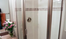 Beautiful, new corner shower unit and custom tile